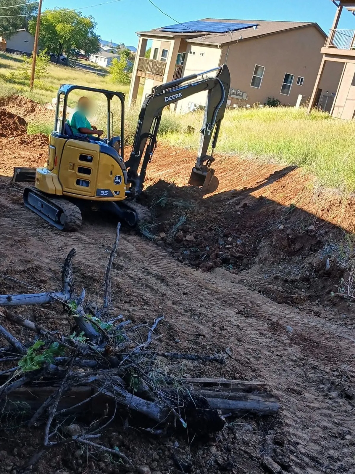 Mill Iron B mini excavator clearing a residential lot