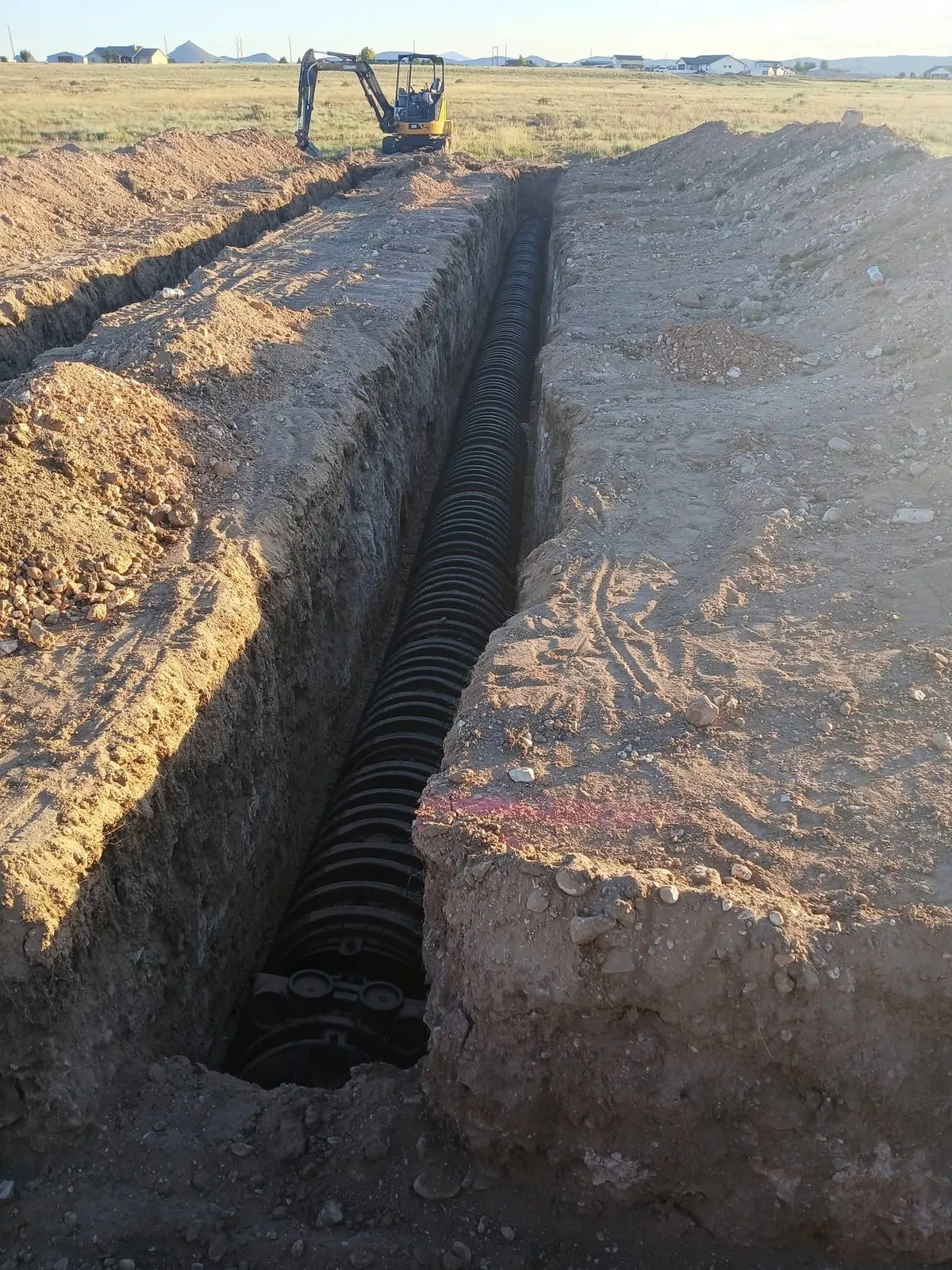 A leach field trench dug by Mill Iron B with chambers set in the bottom